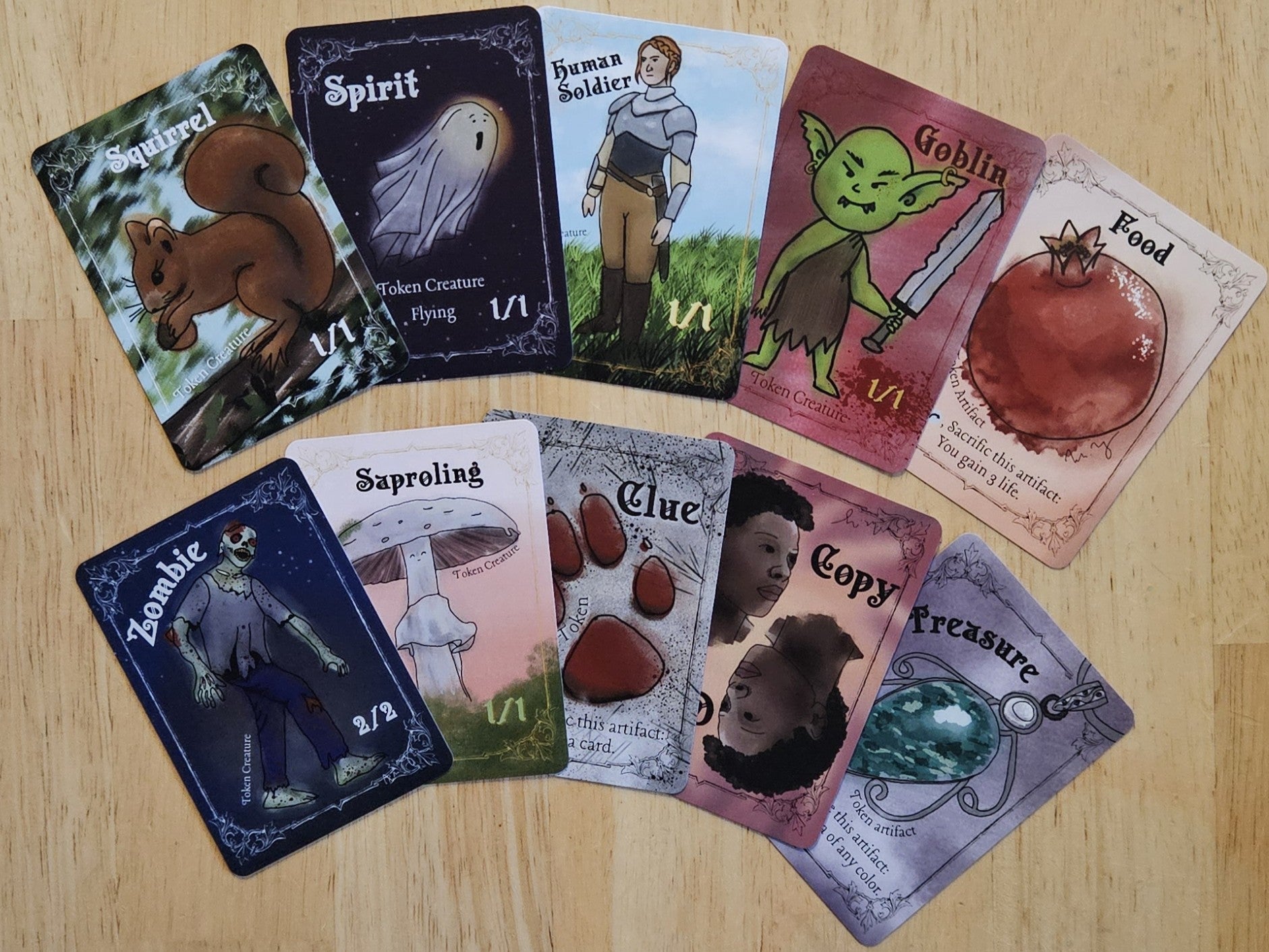 Collection of 10 MTG Token cards fanned out on a wooden surface