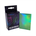 Box of Prismatic Defender holographic card sleeves with a sample sleeve displayed.
