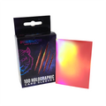 Box of Prismatic Defender holographic card sleeves with a sample sleeve displayed.
