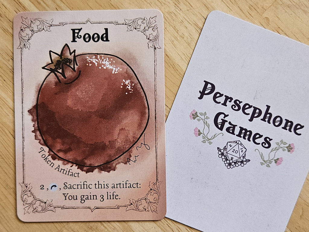 Illustrated food token card featuring a  watercolor style pomegranate 