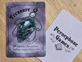 Illustrated treasure token card featuring green marbled gemstone pendant in a silver filigree setting