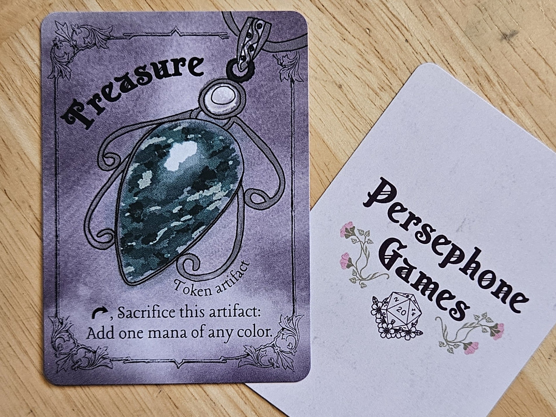 Illustrated treasure token card featuring green marbled gemstone pendant in a silver filigree setting